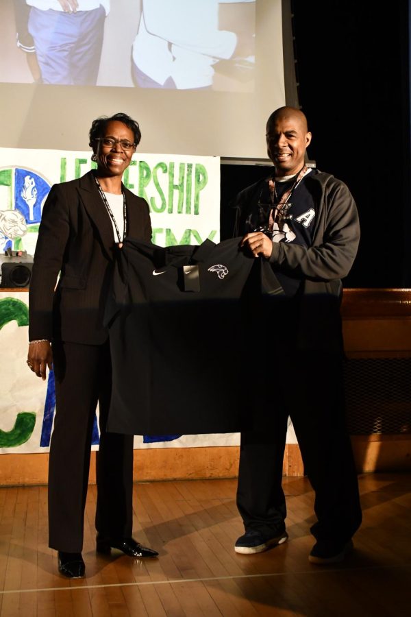 Dr. Lisa Langston, FWISD Director of Athletics presents Coach H. Lee with his Black Shirt Award